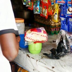 A local market stall in Abuja displaying various packaged goods on a counter.