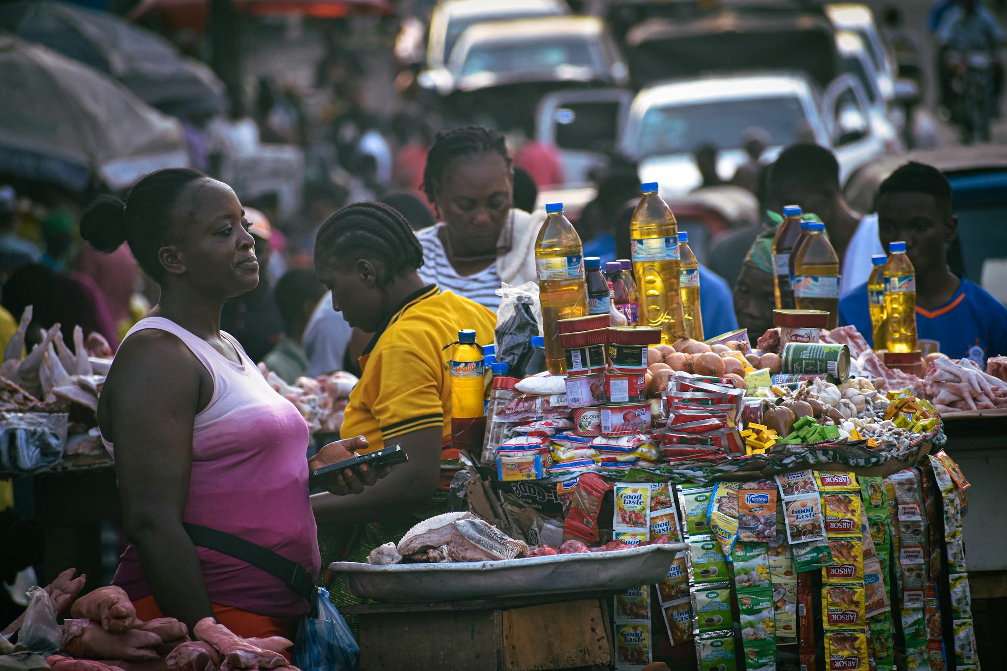 Bustling street market scene in Monrovia, Liberia, featuring diverse people and colorful stalls.