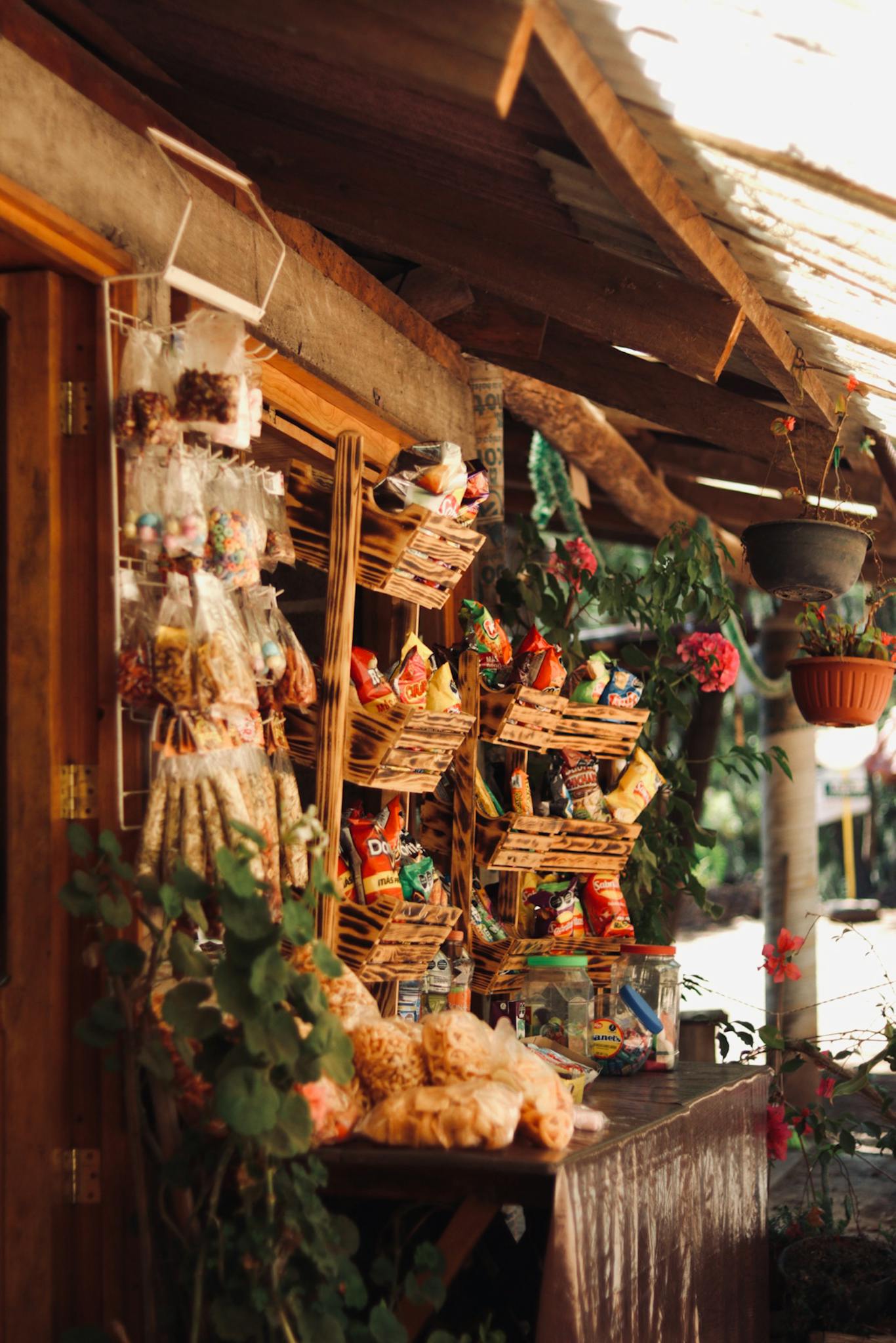 Outdoor market stall with a variety of locally made products and vibrant decor.